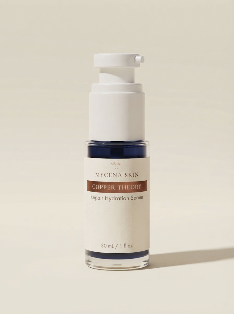 Copper Theory in a white airless pump bottle, navy-blue serum visible through the clear base